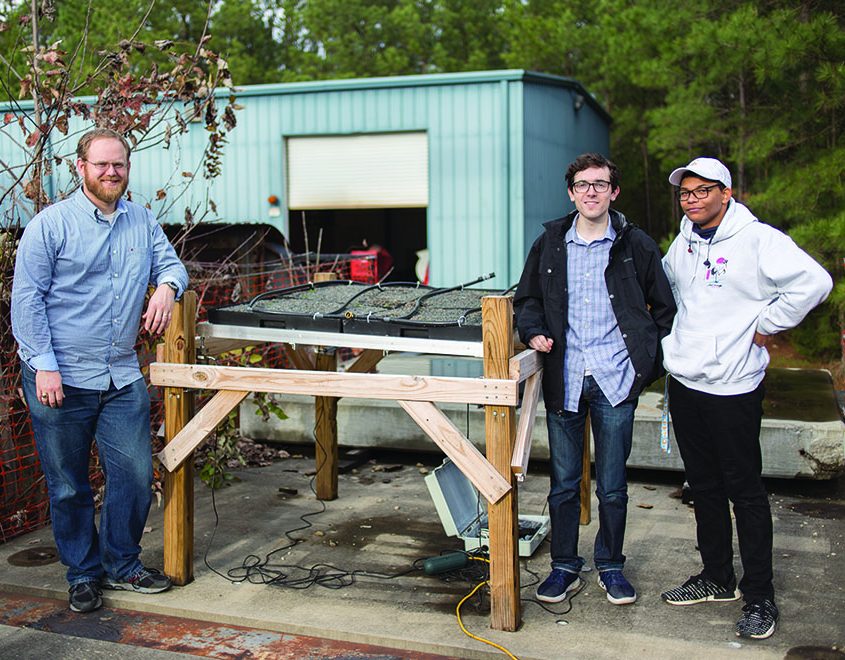 Dr. Martin, Donovan Rice and Patrick Fuller working on the table-top green roof model. Photo by Sarah Stewart